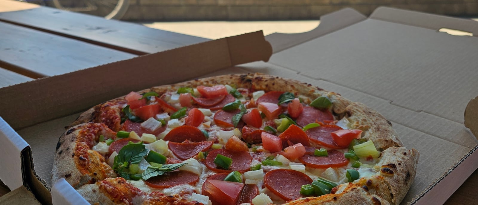 A fresh thin-crust pepperoni and vegetable pizza in the box at Lu Lou's Lakeside Grill in Oyama, BC