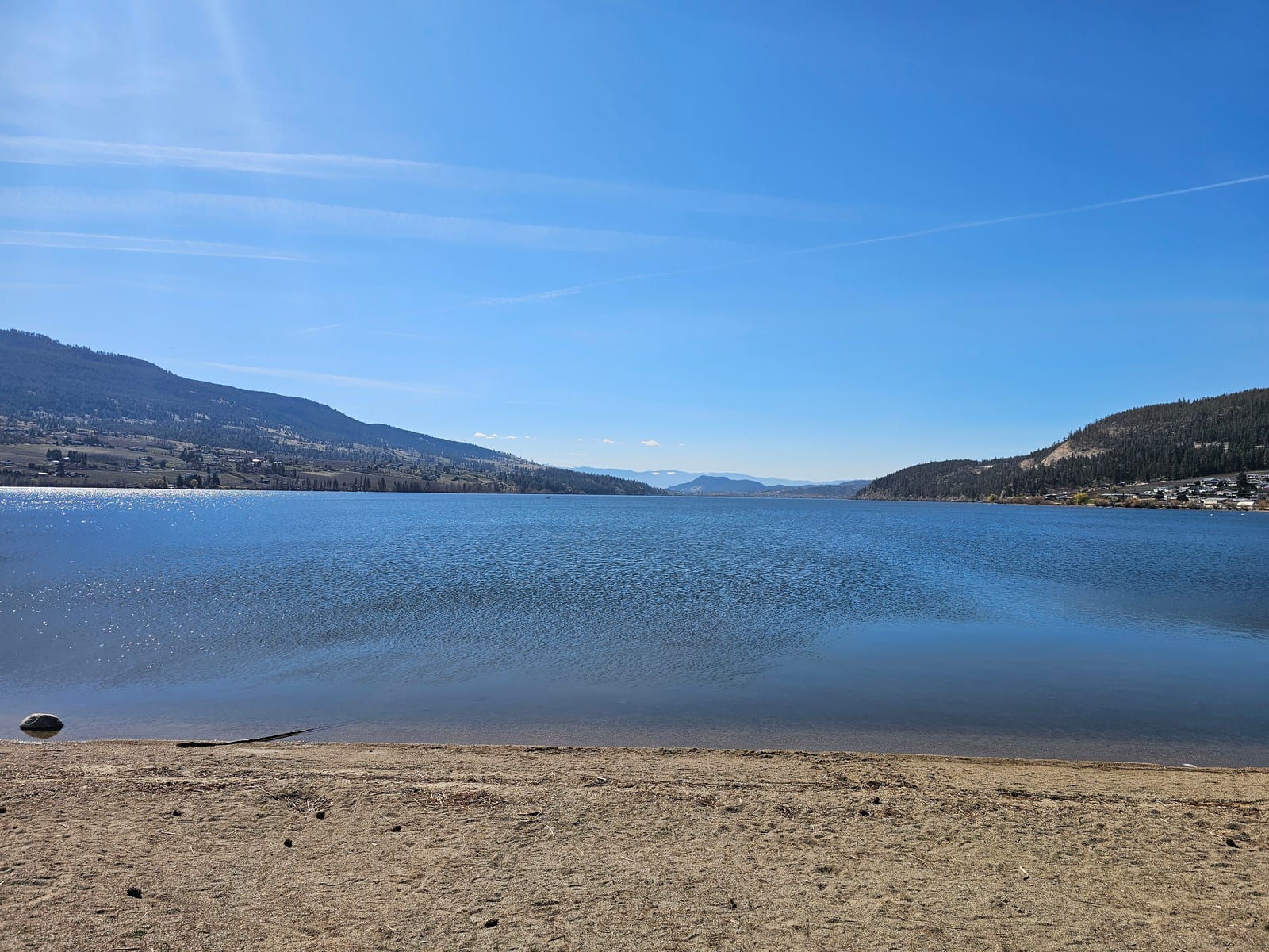 Wood Lake on a calm day from the beach in Oyama, BC